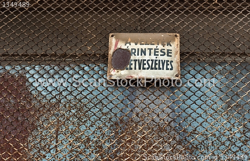 Image of Danger! High voltage sign on metal fence