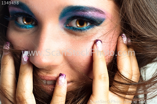 Image of Young model touching her face with her fingers