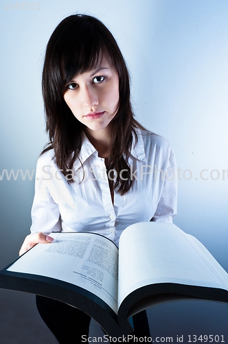 Image of Confident business woman holding a book