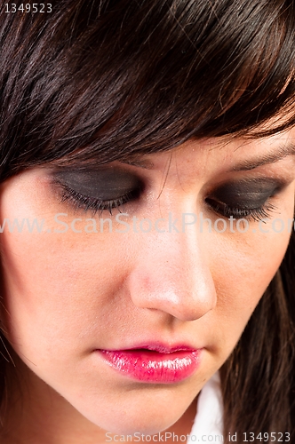 Image of Depressed young woman closing her eyes