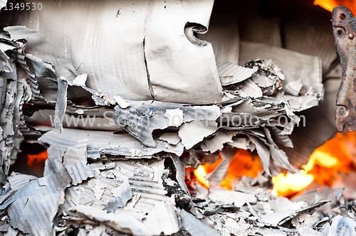 Image of Paper burning in recycle barrel