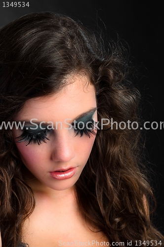 Image of Portrait of a young fashion modell against dark background