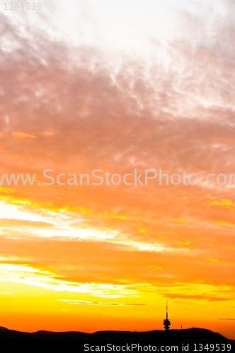 Image of Sunset with orange clouds and silhouette of the mountains