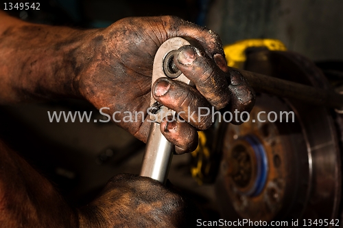 Image of Hard working man with hands full of oil