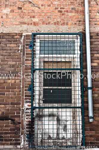 Image of Door of an abandoned facility with bars