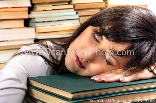 Image of Exhausted student girl and her books