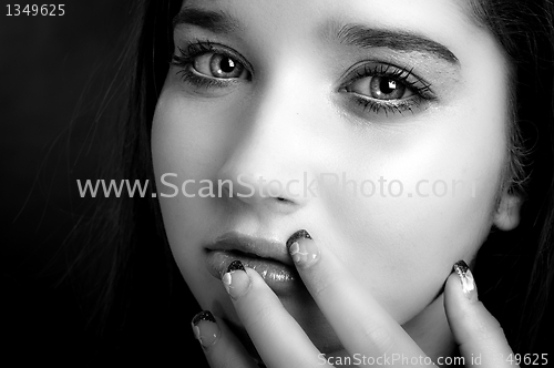Image of Young model touching her face with her fingers