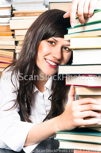 Image of School girl holding her books and smiling