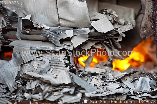 Image of Flame burning in barrel with papers