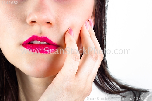 Image of Closeup of a girl holding her cheek
