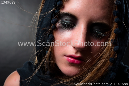 Image of Girl in black scarf looking down