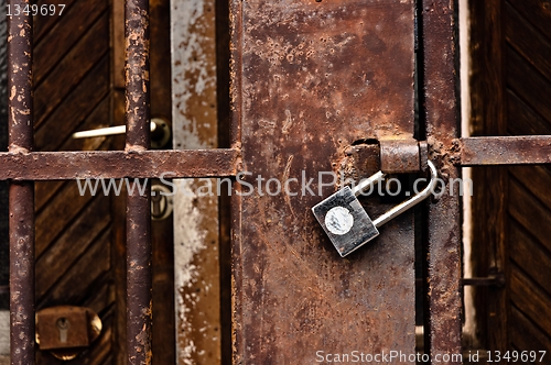 Image of Old rusty padlock on cell door