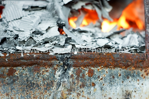 Image of Paper burning in recycle barrel