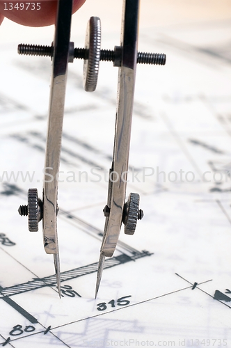 Image of Hand holding bow on construction plans
