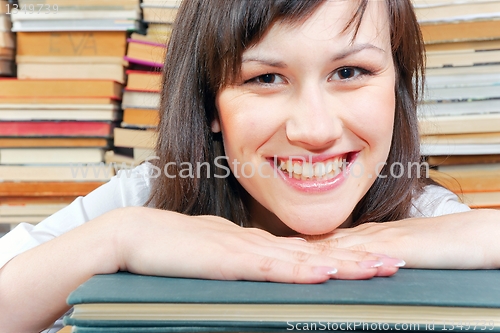 Image of Cheerful young university student  and her books