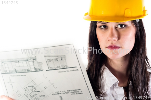 Image of Pretty business woman in yellow helmet and her plans