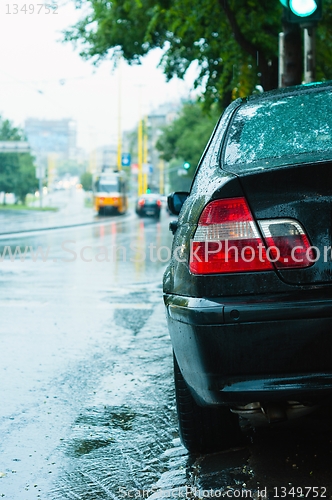 Image of Closeup shot of a parking car in the rain with blurry background