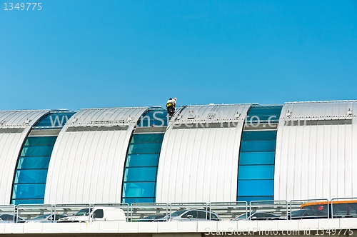 Image of Two workers finishing the construction on a hot day