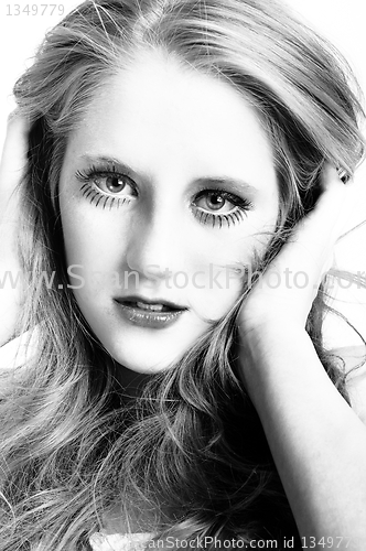 Image of Portrait of a young woman holding her long hair