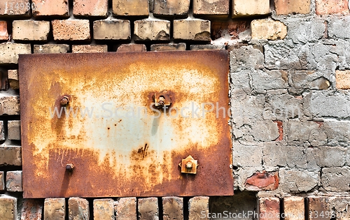 Image of Abandoned wall texture with metal plate