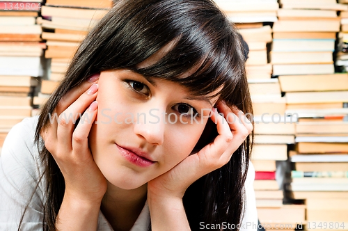 Image of Young student reading a book in the library