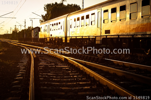 Image of Train passing by in orange sunset