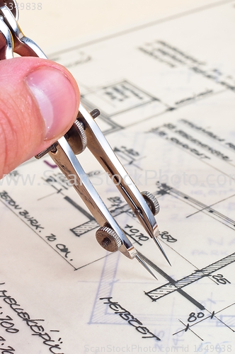 Image of Hands of an engineer with construction plans