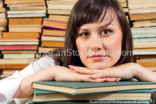 Image of Portrait of a young student against piled up books