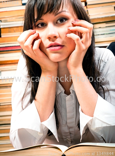 Image of Young school student over a book