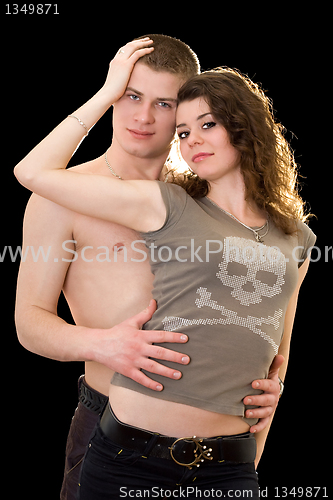 Image of Pretty loving young couple. Isolated on black