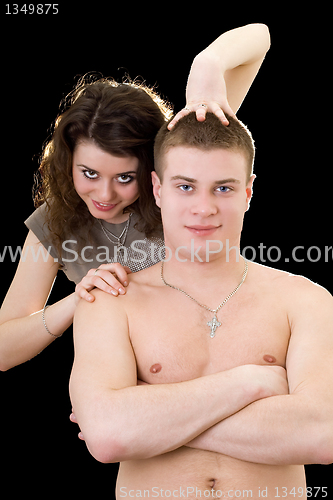 Image of Beautiful playful young couple. Isolated on black