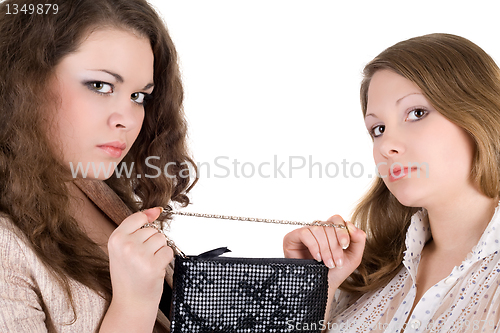 Image of Quarrel of two beautiful girls because of a handbag