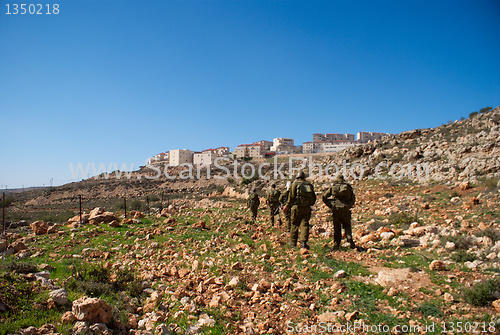 Image of Israeli soldiers patrol in palestinian village