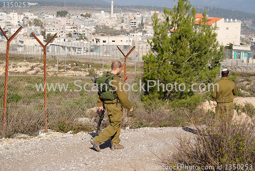 Image of Israeli soldiers patrol in palestinian village