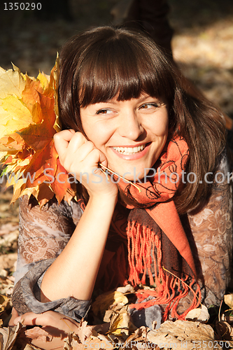 Image of woman with autumn leaves