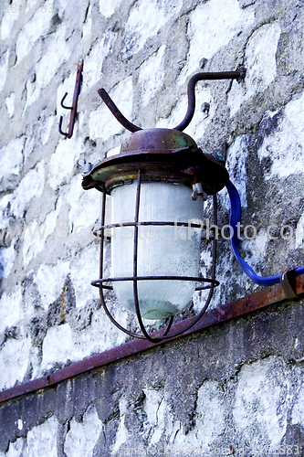 Image of Street lamp hanging on wall of bricks