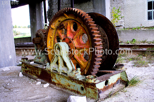 Image of Rusty mine shaft mechanism on dusty ground