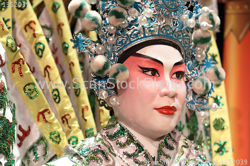 Image of chinese opera dummy and red cloth as text space ,it is a toy,not