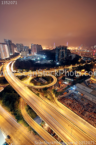 Image of Freeway in night with cars light in modern city. 