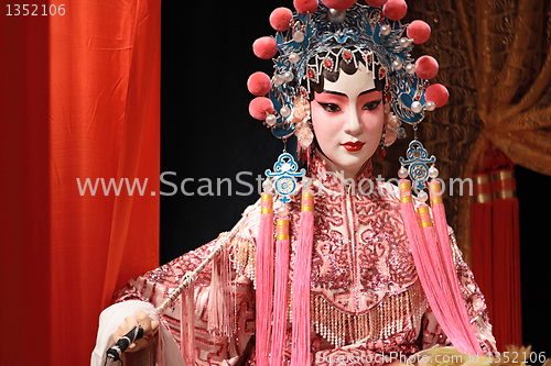 Image of chinese opera dummy and red cloth as text space ,it is a toy,not