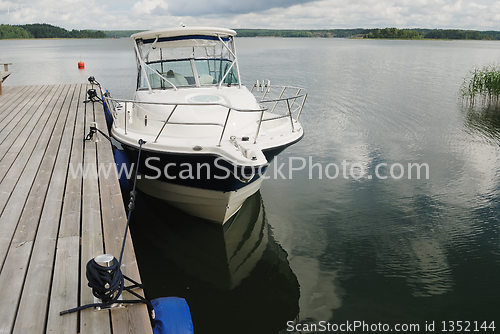 Image of big white boat tied up at the seashore