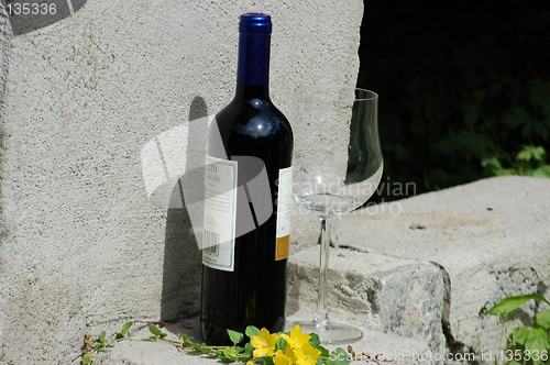 Image of Red wine and glass on concrete