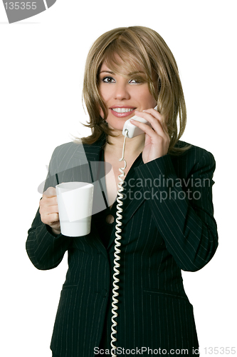 Image of Woman with coffee answers a phone