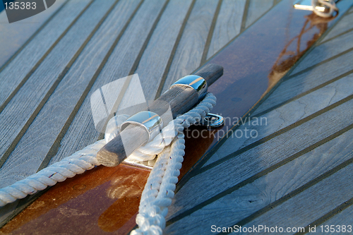 Image of Cleat and rope on a wooden sailboat