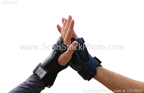 Image of Teen arms in roller wrist guards salutation isolated