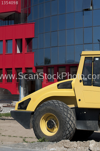 Image of Excavator in fron of newly building 