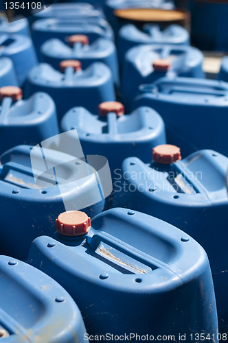 Image of Old blue canisters for oil products
