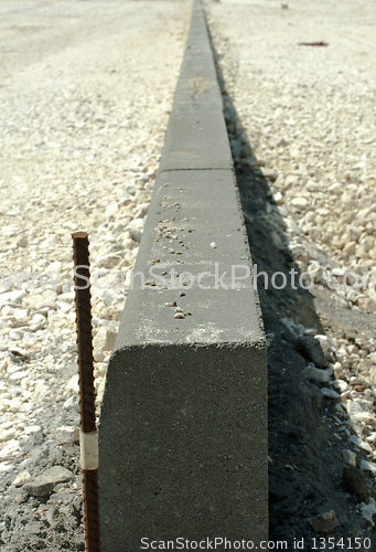 Image of Curb and gravel on the road in repair. Placed 