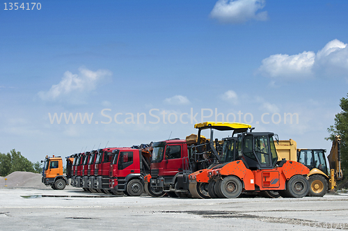 Image of Trucks, rollers and machinery for asphalting