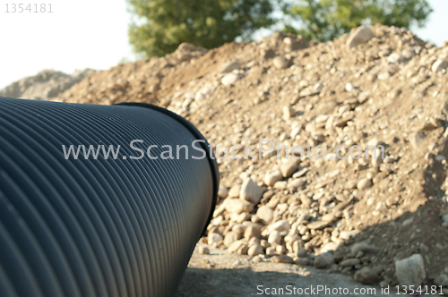 Image of Pipes and piles of sand in the background